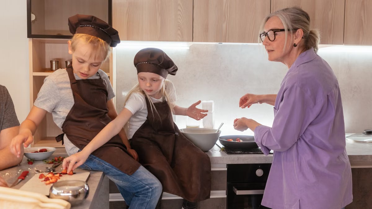 Elderly woman and children cooking together, fostering family bonding.